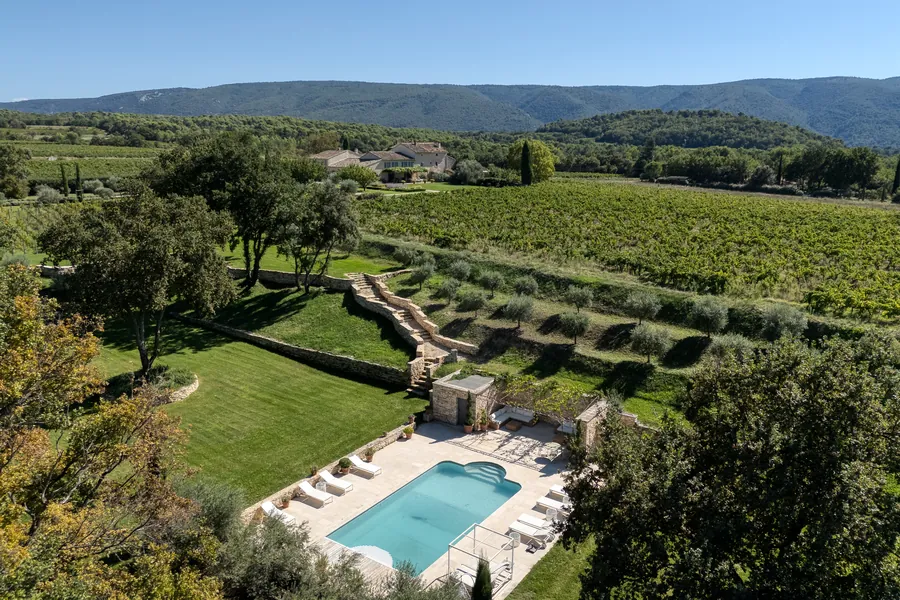 The pool from above, with vineyards and the Luberon hills