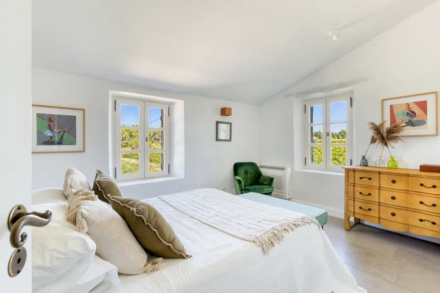 A bright bedroom overlooking the vines