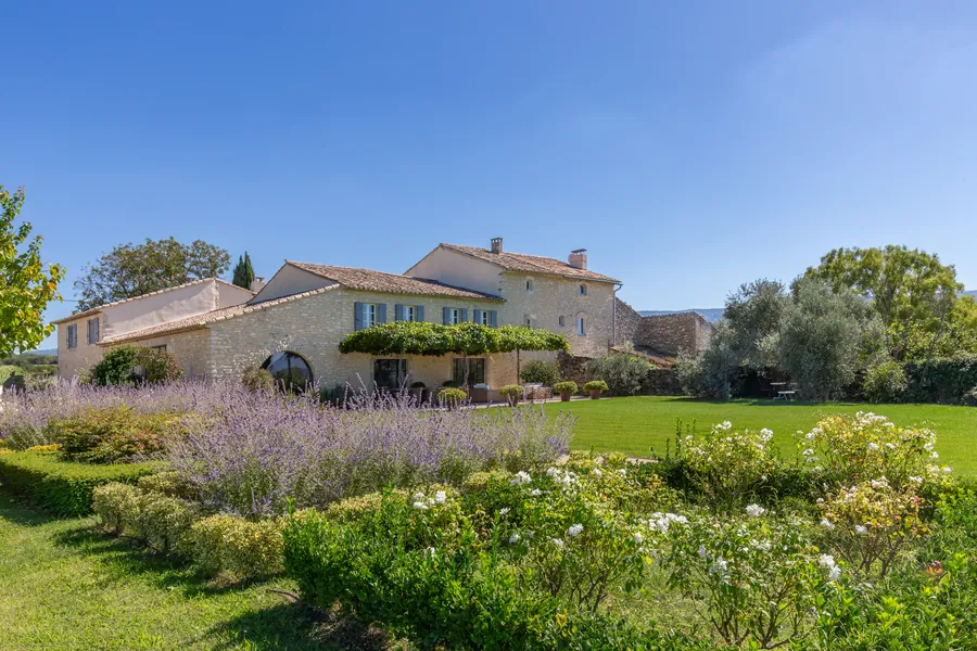 The house across a garden of lavender and roses