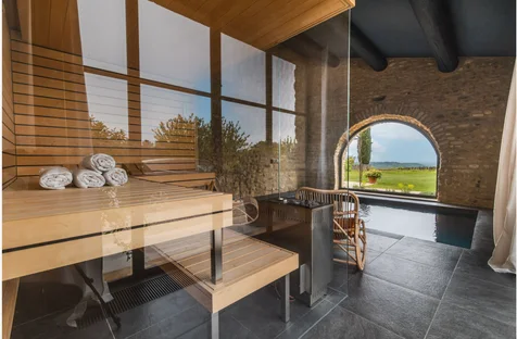The Finnish sauna with glass walls and a view through an arched window